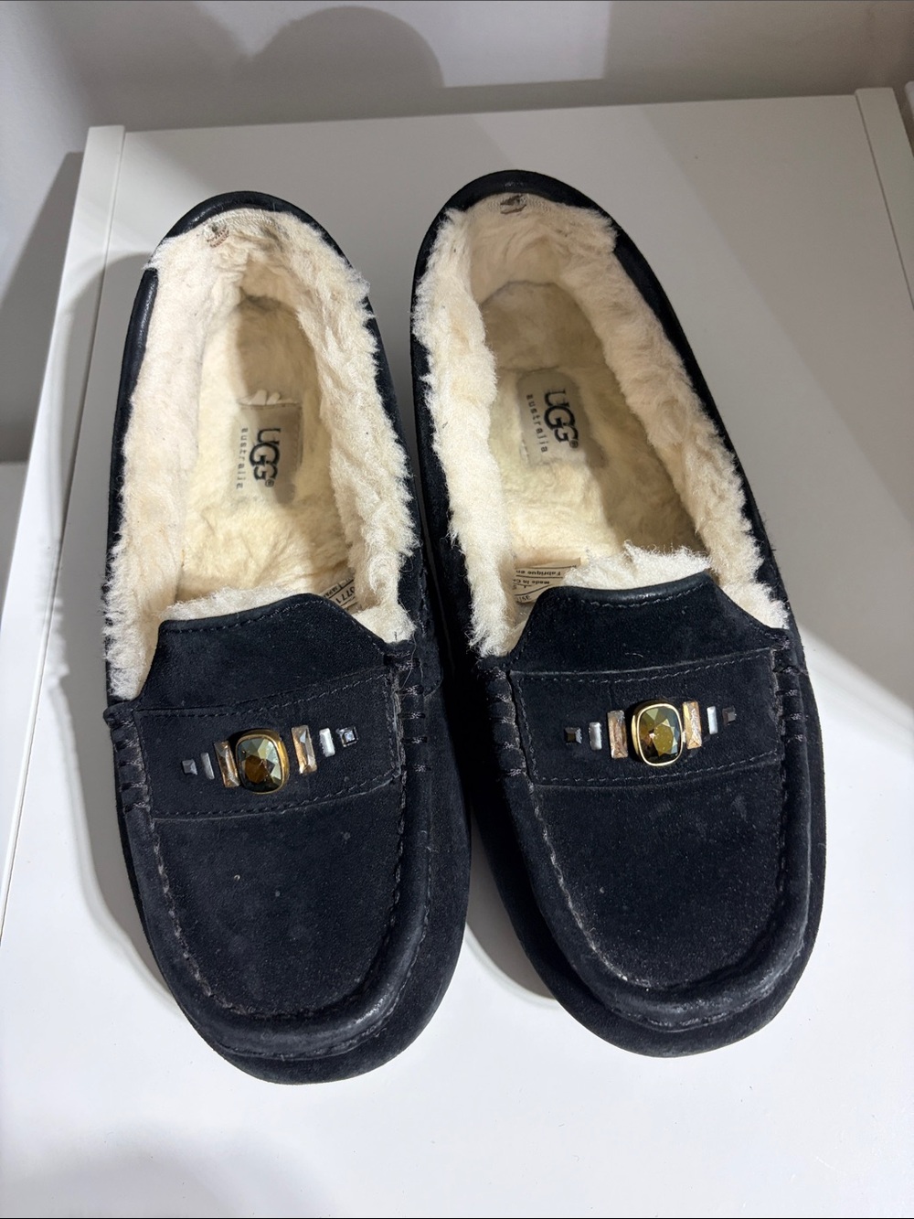 UGG Black Suede Shearling-Lined Moccasin Slippers with Decorative Accent